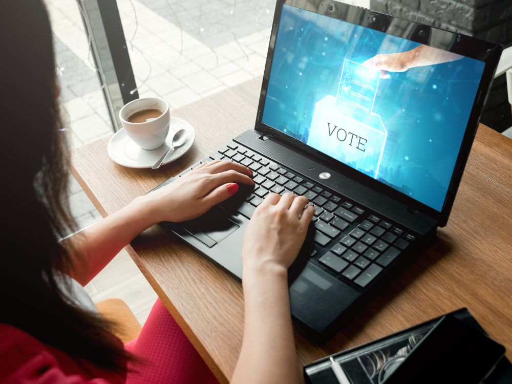 person using computer with a voting photo on the screen